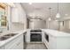 Elegant kitchen with white countertops, stainless steel appliances, and contemporary lighting at 530 Village Green Sw Ct, Lilburn, GA 30047