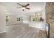 Bright, open-concept living space features a brick fireplace and seamless flow into the modern kitchen area at 530 Village Green Sw Ct, Lilburn, GA 30047