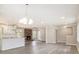 Bright and airy living space featuring a fireplace, open kitchen, and modern flooring at 530 Village Green Sw Ct, Lilburn, GA 30047