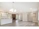 Bright living room features gray vinyl floors, brick fireplace and seamless flow to the kitchen with island seating at 530 Village Green Sw Ct, Lilburn, GA 30047