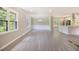 Bright, open living area with large windows, elegant lighting, and modern flooring at 530 Village Green Sw Ct, Lilburn, GA 30047