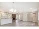 Spacious living room with updated floors, fireplace, and an open layout to the stylish kitchen at 530 Village Green Sw Ct, Lilburn, GA 30047