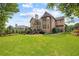 Picturesque backyard with lush green lawn, mature trees and deck off the house at 1235 Grand View Se Dr, Smyrna, GA 30126