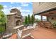 Outdoor deck area with an stone fireplace, wood railing, seating area, and a serene backyard view at 1235 Grand View Se Dr, Smyrna, GA 30126