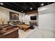 Finished basement features a brick accent wall, exposed ceiling, and comfortable leather seating area at 1235 Grand View Se Dr, Smyrna, GA 30126
