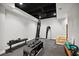 Basement gym area with black rubber flooring, training equipment, punching bag and exposed black ceiling at 1235 Grand View Se Dr, Smyrna, GA 30126