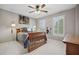 Cozy bedroom featuring neutral walls, soft carpeting, ceiling fan, and natural light from window with shutters at 1235 Grand View Se Dr, Smyrna, GA 30126