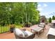 Expansive wooden deck features an outdoor seating area and wrought iron railing with trees at 1235 Grand View Se Dr, Smyrna, GA 30126
