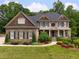 A stately brick and shingle two-story home with manicured landscaping, front porch, and symmetrical design at 1235 Grand View Se Dr, Smyrna, GA 30126