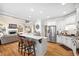 Modern eat-in kitchen with white cabinets, stainless steel appliances, and breakfast bar seating at 1235 Grand View Se Dr, Smyrna, GA 30126