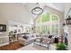 Bright open living area with large arched windows, hardwood floors, and elegant fireplace at 1235 Grand View Se Dr, Smyrna, GA 30126
