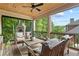 Covered porch with wood ceiling, ceiling fan, comfortable seating, and stone fireplace for outdoor gatherings at 1235 Grand View Se Dr, Smyrna, GA 30126