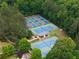 Overhead view of multiple tennis courts surrounded by lush green trees at 1235 Grand View Se Dr, Smyrna, GA 30126