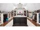 Spacious walk-in closet with custom island, wood floors, and beautiful lighting at 1235 Grand View Se Dr, Smyrna, GA 30126