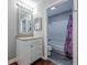 Well-lit bathroom with a white vanity and a shower with a colorful curtain at 2015 Wingate Way, Atlanta, GA 30350
