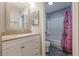 Bathroom featuring a white vanity and a shower with a colorful curtain at 2015 Wingate Way, Atlanta, GA 30350