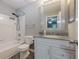 Bathroom with updated vanity and shower-tub combo with white tile at 2015 Wingate Way, Atlanta, GA 30350