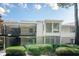Charming condo with white siding, a balcony, and lush landscaping at 2015 Wingate Way, Atlanta, GA 30350
