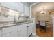 Kitchen boasts white cabinets, stainless steel sink, and easy access to the dining area at 2015 Wingate Way, Atlanta, GA 30350