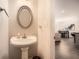 Powder room with a pedestal sink and view into the dining area at 3070 Fareed St, Douglasville, GA 30135