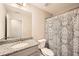 Bathroom featuring a vanity with granite countertop, toilet, and shower with patterned curtain at 3070 Fareed St, Douglasville, GA 30135
