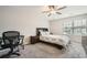 Bright bedroom with neutral walls, ceiling fan, carpet, and a desk at 3070 Fareed St, Douglasville, GA 30135