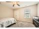 Bright bedroom with neutral walls, ceiling fan, carpet, and closet with mirrored doors at 3070 Fareed St, Douglasville, GA 30135
