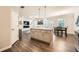 Open-concept kitchen with island and granite countertops, seamlessly flowing into the living and dining areas at 3070 Fareed St, Douglasville, GA 30135
