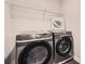 Modern laundry room featuring new front load washer and dryer at 3070 Fareed St, Douglasville, GA 30135