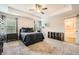 Spacious main bedroom with trey ceiling and a barn door to the ensuite bathroom at 3070 Fareed St, Douglasville, GA 30135