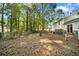 Large, secluded backyard with mature trees, wooden fence, and access to a patio, perfect for outdoor activities at 3227 Fescue Cir, Lawrenceville, GA 30044