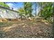 Expansive backyard featuring mature trees and a wooden fence, providing privacy and space for various outdoor activities at 3227 Fescue Cir, Lawrenceville, GA 30044