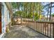 Concrete patio overlooking lush green backyard with trees and a wooden fence at 3227 Fescue Cir, Lawrenceville, GA 30044
