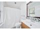 Bright bathroom featuring wooden vanity, updated sink and shower with curtain at 3227 Fescue Cir, Lawrenceville, GA 30044