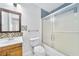 Well lit bathroom with wooden vanity, mosaic tiles, and walk in shower at 3227 Fescue Cir, Lawrenceville, GA 30044