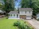 Charming two-story home featuring a well-maintained lawn, stone accents, a covered porch, and an attached garage at 3227 Fescue Cir, Lawrenceville, GA 30044