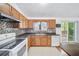 Well-lit kitchen features sleek countertops, tile backsplash, and convenient access to the deck at 3227 Fescue Cir, Lawrenceville, GA 30044