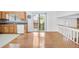 The kitchen features wood cabinets, black counters, tile floors and a sliding glass door at 3227 Fescue Cir, Lawrenceville, GA 30044