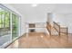 Spacious living room featuring hardwood floors, access to deck, and a charming stone fireplace at 3227 Fescue Cir, Lawrenceville, GA 30044
