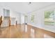 Spacious living area with hardwood floors, staircase, neutral walls, and a large window bringing in natural light at 3227 Fescue Cir, Lawrenceville, GA 30044