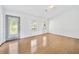 Inviting living space featuring gleaming hardwood floors, neutral walls, and a stylish front door with decorative glass at 3227 Fescue Cir, Lawrenceville, GA 30044