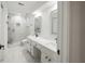 Modern bathroom with a double vanity, a glass enclosed shower, and white tile at 3649 Peachtree Ne Rd # 305, Atlanta, GA 30319