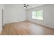A bright bedroom with hardwood flooring, a ceiling fan and a large window at 3649 Peachtree Ne Rd # 305, Atlanta, GA 30319