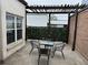 Relaxing patio with a table and chairs, pergola, and privacy wall at 3649 Peachtree Ne Rd # 305, Atlanta, GA 30319