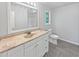 Bathroom featuring a window, toilet, and vanity at 6795 Browns Mill Walk, Lithonia, GA 30038