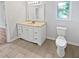 Bright bathroom with a window, toilet, and vanity at 6795 Browns Mill Walk, Lithonia, GA 30038