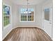 Dining room area featuring hardwood floors, natural light, and access to back porch at 6795 Browns Mill Walk, Lithonia, GA 30038