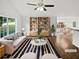 Bright, staged living room featuring hardwood floors and vaulted ceilings, bathed in natural light at 6795 Browns Mill Walk, Lithonia, GA 30038