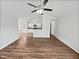 Open-concept living room featuring hardwood floors and vaulted ceilings with kitchen access at 6795 Browns Mill Walk, Lithonia, GA 30038