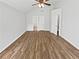 Main bedroom featuring hardwood floors, ceiling fan, and ensuite access at 6795 Browns Mill Walk, Lithonia, GA 30038